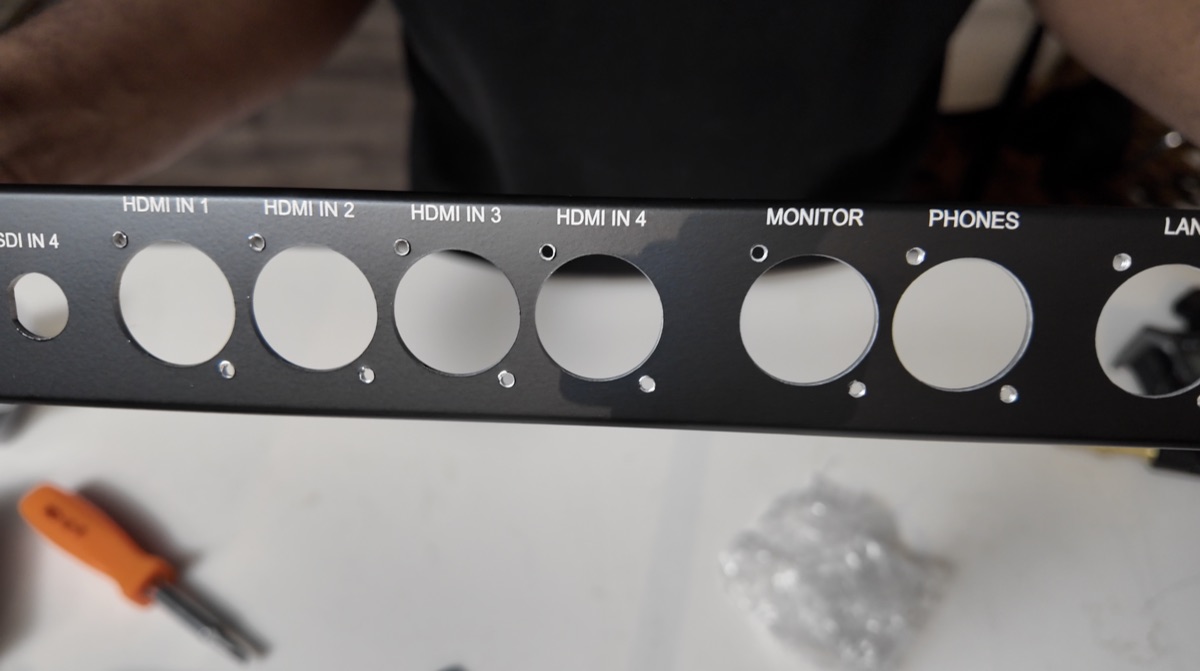 Close-up of the custom panel's HDMI, monitor, and headphone cutouts and labels.