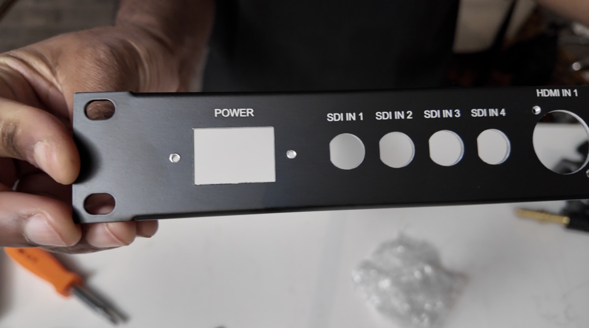 Power inlet and four SDI cutouts on the left side of the custom panel.